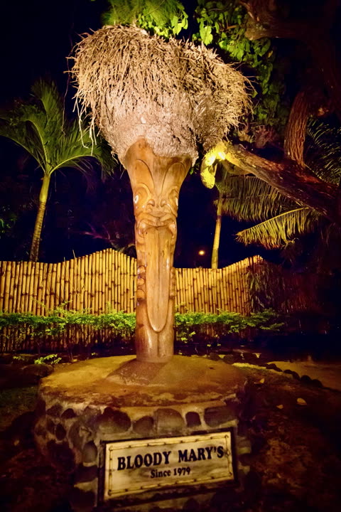 The carved tiki at the entrance to Bloody Mary’s, above a sign reading “Bloody Mary’s, Since 1979”